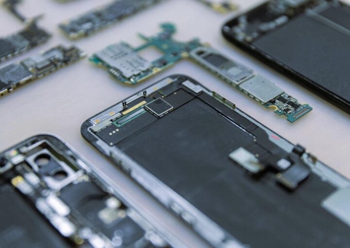 a group of smartphones displayed on a wooden table