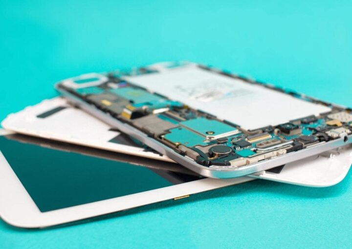 A close up of a cell phone with a cracked screen