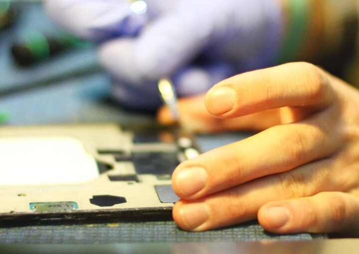 a person typing on a laptop keyboard