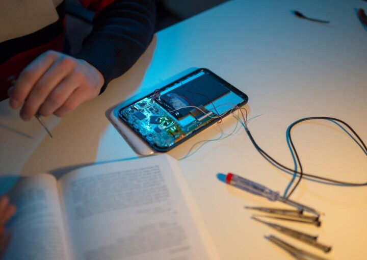 a person sitting at a table with a book and cell phone, enjoying a moment of relaxation